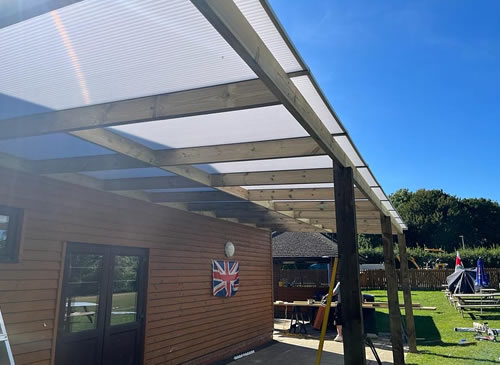 covered outdoor seating area created at Maple Cross Club